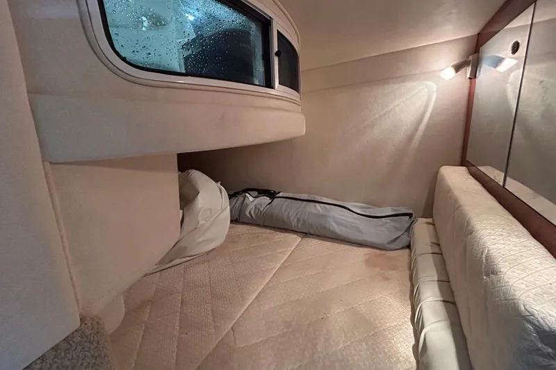 Slide: The Image of Interior cabin of 2004 Sea Ray Sundancer 280 with cozy sleeping area and window. - 18