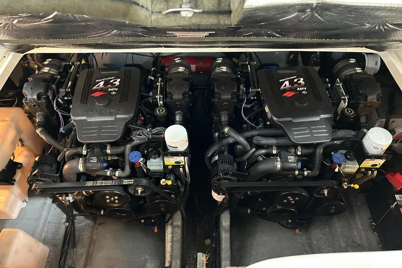 Slide: The Image of Twin engines of a 2004 Sea Ray Sundancer 280 boat, showcasing detailed mechanical components. - 19