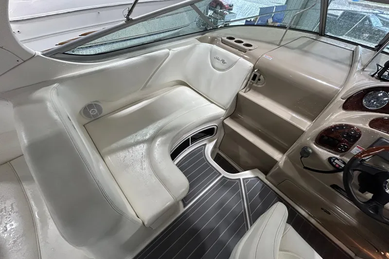 Slide: The Image of 2004 Sea Ray Sundancer 280 cockpit with beige seating and sleek dashboard design. - 8