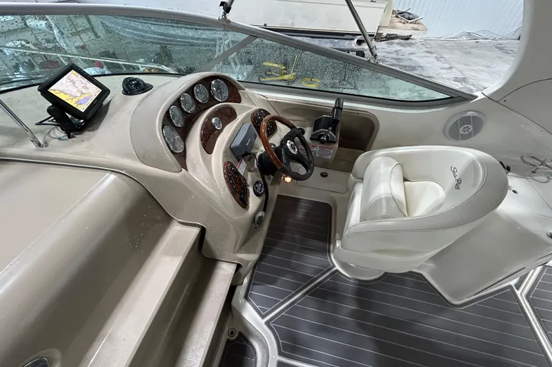 Slide: The Image of 2004 Sea Ray Sundancer 280 helm with navigation system and leather captain's chair. - 9