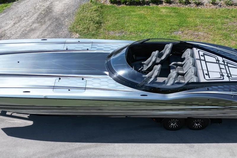 Slide: The Image of 2023 MTI 390X luxury speedboat with sleek design and spacious seating, parked on a driveway. - 10