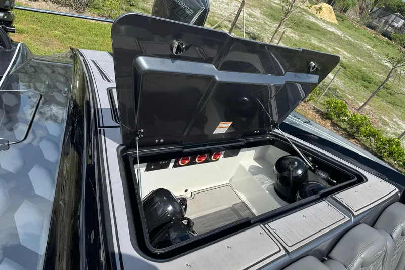 Slide: The Image of Open storage compartment on 2023 MTI 390X boat, showcasing interior features and equipment. - 18
