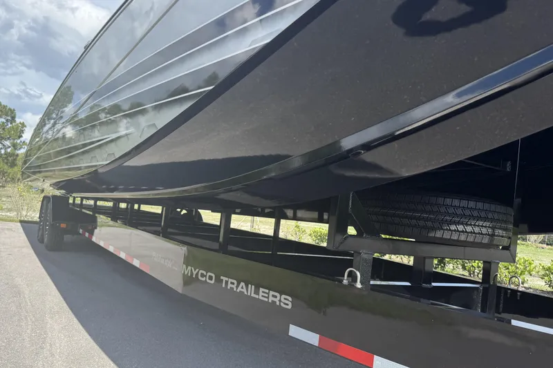 Slide: The Image of 2023 MTI 390X boat on Myco trailer, showcasing sleek design and sturdy construction. - 19