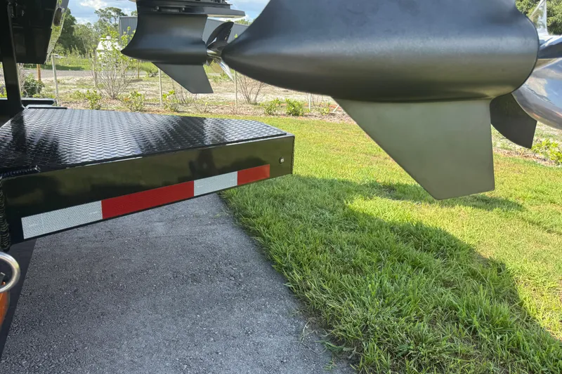 Slide: The Image of Trailer with reflective tape and propellers, MTI 390X, 2023 model, parked on grass. - 22