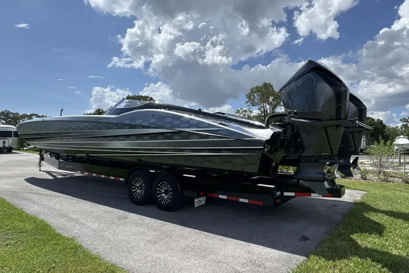 Slide: The Image of 2023 MTI 390X powerboat on trailer under cloudy sky. - 3
