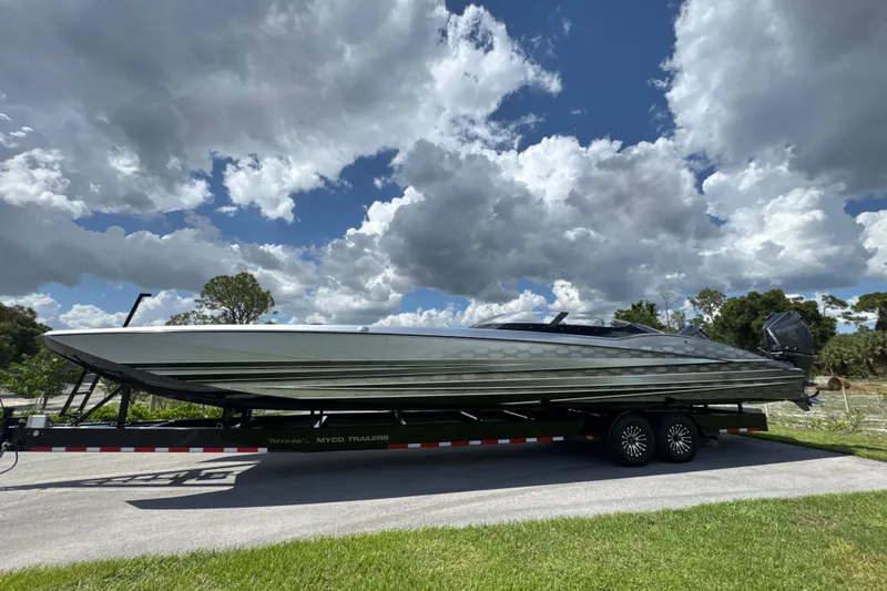 Slide: The Image of 2023 MTI 390X boat on trailer under cloudy sky. - 9