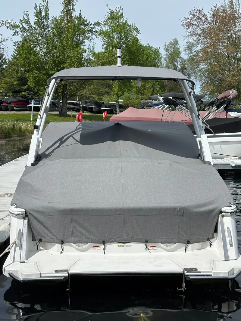 Slide: The Image of 2025 Cobalt R4 boat with gray cover at dock. - 2