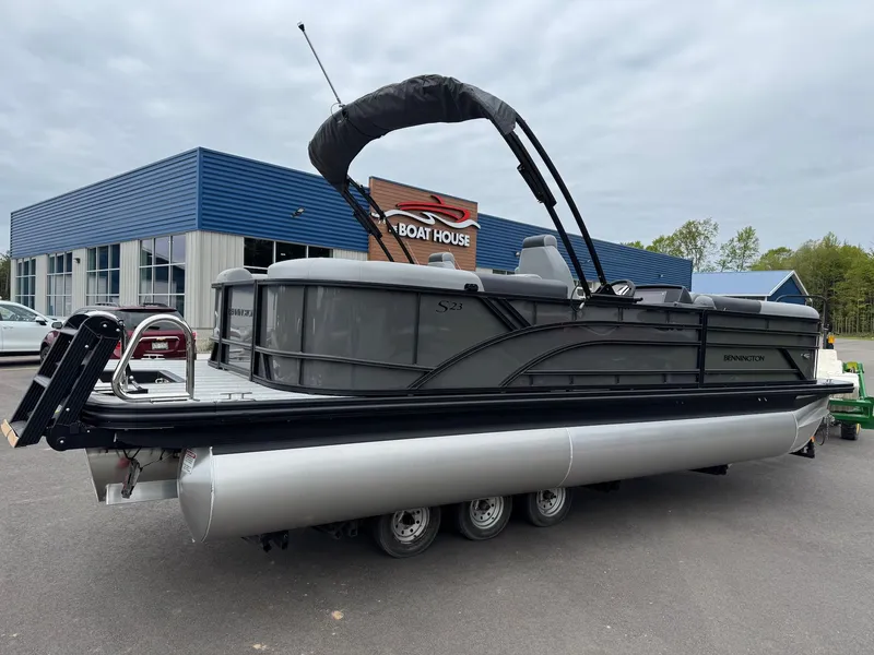 Slide: The Image of 2026 Bennington 23SSR SPS LTD TRI pontoon boat in front of a boathouse. - 15