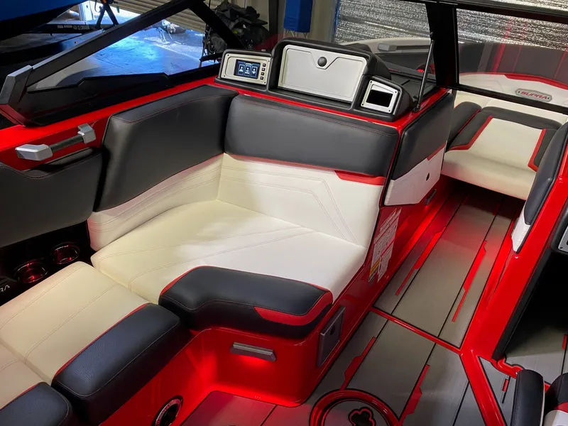 Slide: The Image of Interior of a 2021 Supra SL 400 boat with red accents. - 14