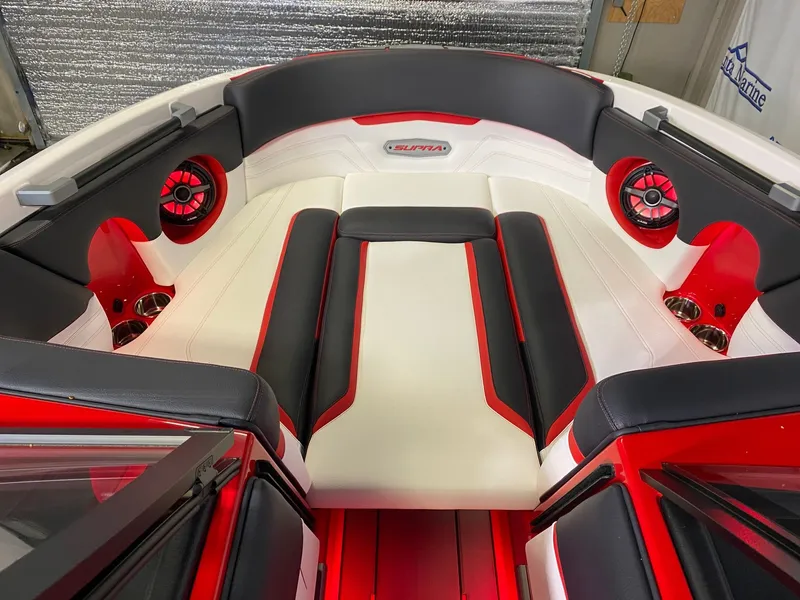 Slide: The Image of Interior of a 2021 Supra SL 400 boat with red and black accents. - 21