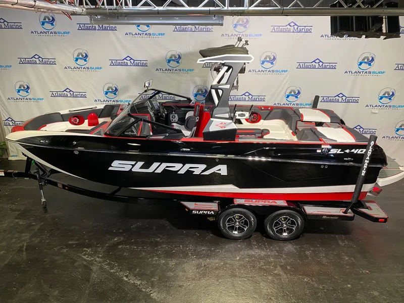Slide: The Image of 2021 Supra SL 400 boat displayed in a showroom. - 7