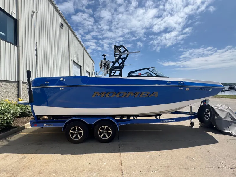 The Image of 2018 Moomba Max boat on trailer outside building. - 1
