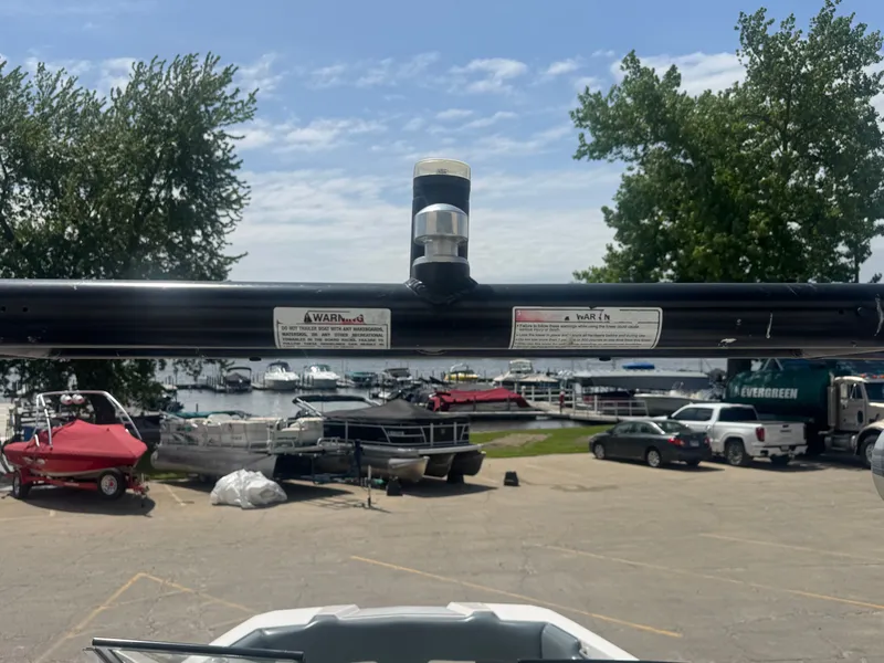 Slide: The Image of 2018 Moomba Max boat with harbor view and trees. - 16