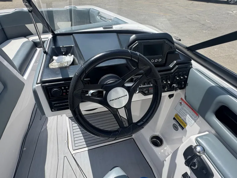 Slide: The Image of Interior view of the helm in a 2018 Moomba Max boat. - 18