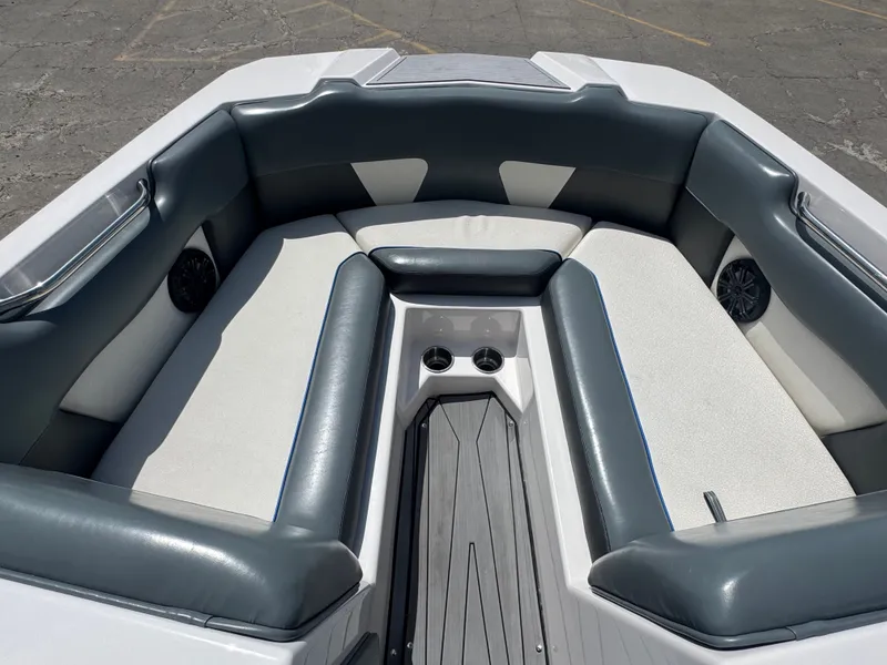 Slide: The Image of Interior of a 2018 Moomba Max boat with gray and white seating. - 19