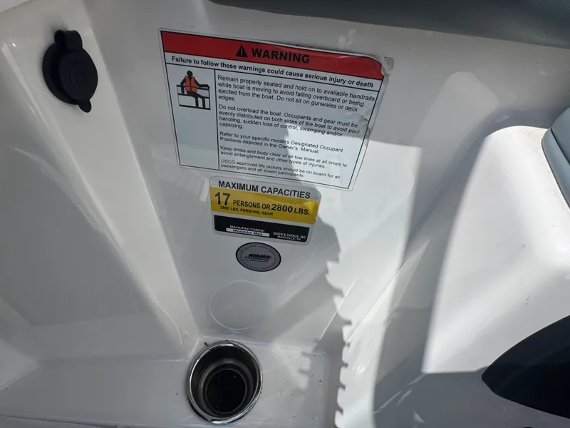 Slide: The Image of Warning and capacity label on a 2018 Moomba Max boat. - 20