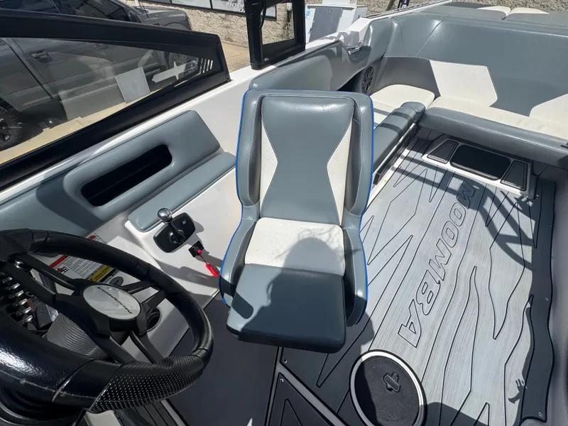 Slide: The Image of Interior of a 2018 Moomba Max boat with steering and seat. - 7