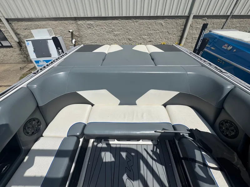 Slide: The Image of Interior of a 2018 Moomba Max boat with gray and white seating. - 8