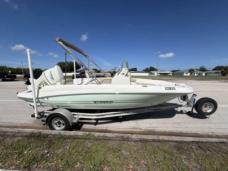 Slide: The Image of 2019 Stingray 186 boat on trailer under sunny skies. - 10