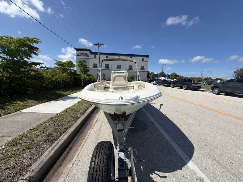 Slide: The Image of 2019 Stingray 186 boat on trailer, sunny day, street in background. - 2