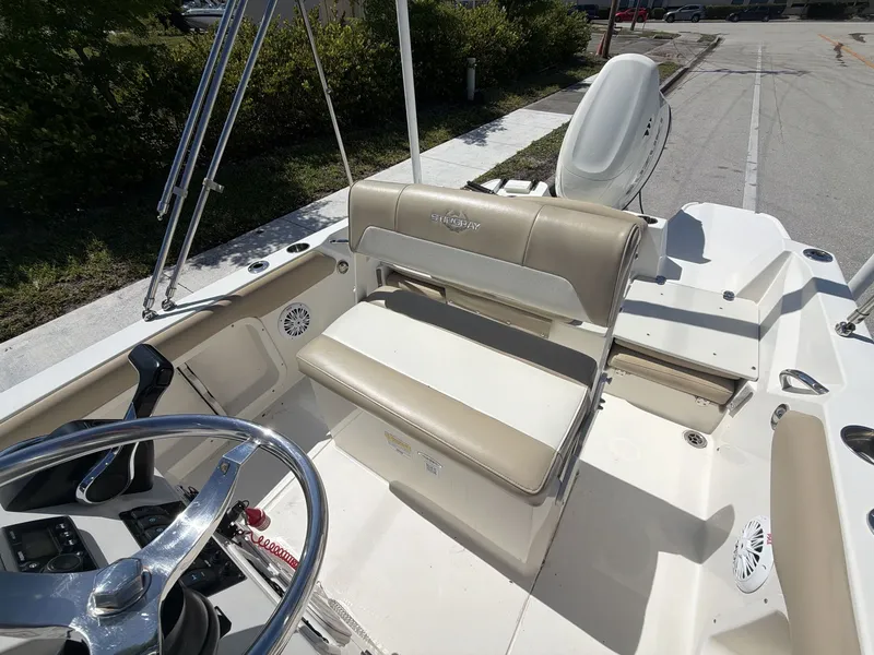 Slide: The Image of Interior of a 2019 Stingray 186 boat with steering wheel and bench seat. - 21