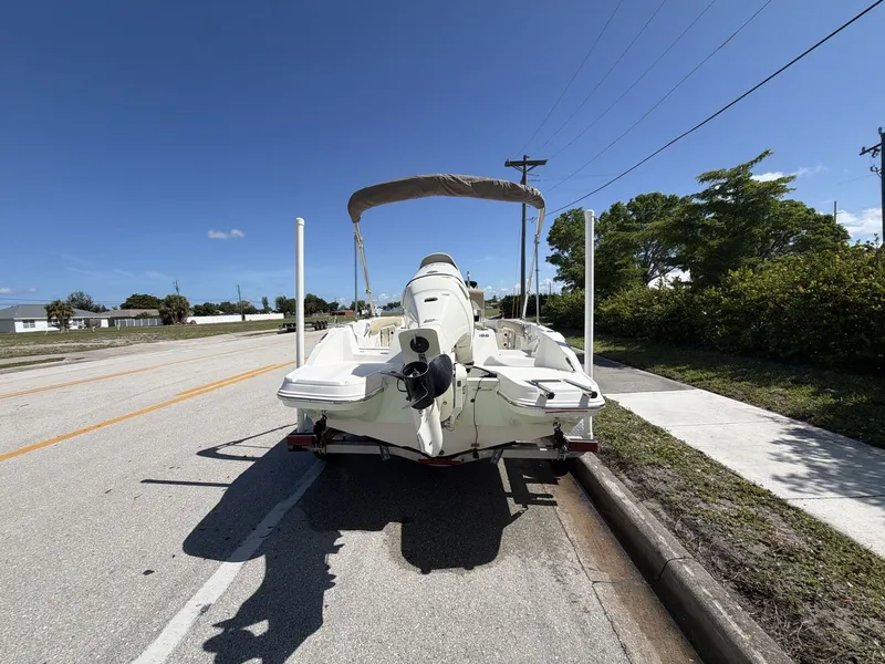 Slide: The Image of 2019 Stingray 186 boat on trailer, sunny day, road in background. - 7