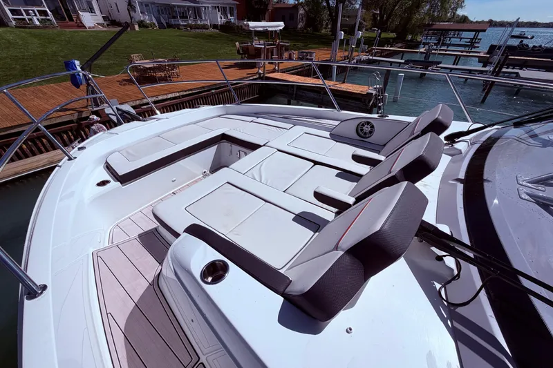 Slide: The Image of 2023 Jeanneau Leader 12.5 WA boat with spacious seating and modern design at a dock. - 10
