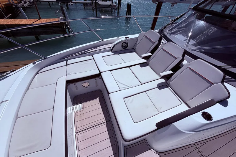 Slide: The Image of Luxurious seating area on 2023 Jeanneau Leader 12.5 WA boat, docked by the water. - 12