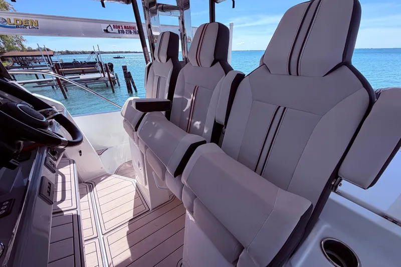 Slide: The Image of 2023 Jeanneau Leader 12.5 WA boat interior with luxurious seating and ocean view. - 13