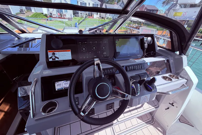Slide: The Image of Cockpit of 2023 Jeanneau Leader 12.5 WA boat with modern navigation controls and steering wheel. - 17