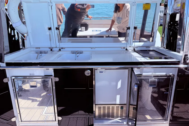Slide: The Image of 2023 Jeanneau Leader 12.5 WA yacht kitchen area with modern appliances and sleek design. - 19