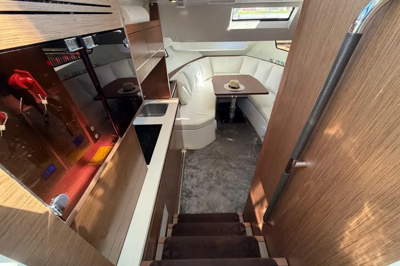 Slide: The Image of Interior of 2023 Jeanneau Leader 12.5 WA yacht with modern kitchen and cozy seating area. - 27