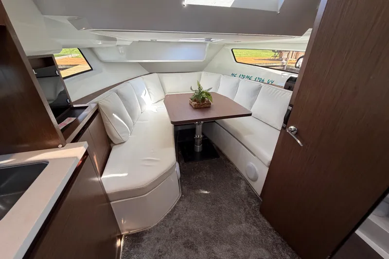 Slide: The Image of Interior of 2023 Jeanneau Leader 12.5 WA with elegant seating and dining area. - 28