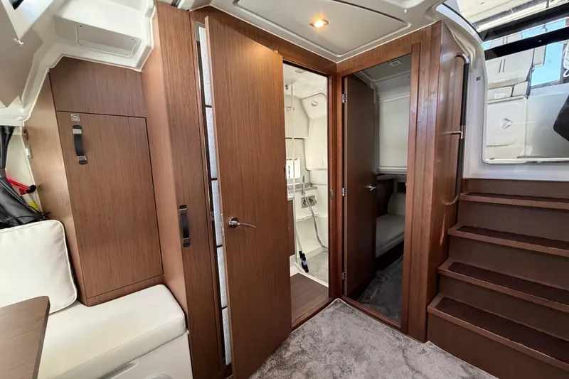 Slide: The Image of Interior of 2023 Jeanneau Leader 12.5 WA, featuring wood finishes and modern design. - 31