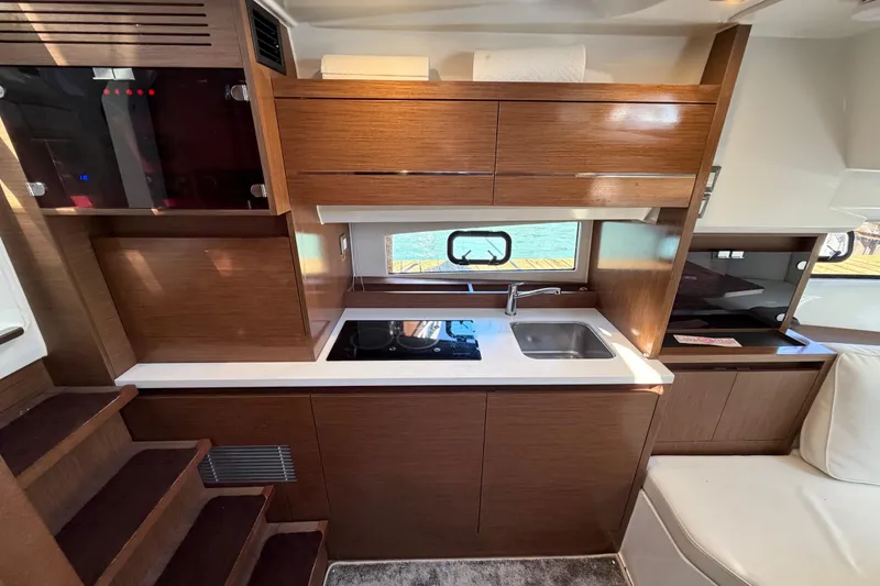 Slide: The Image of Modern kitchen interior of 2023 Jeanneau Leader 12.5 WA yacht with sleek wood cabinetry. - 32