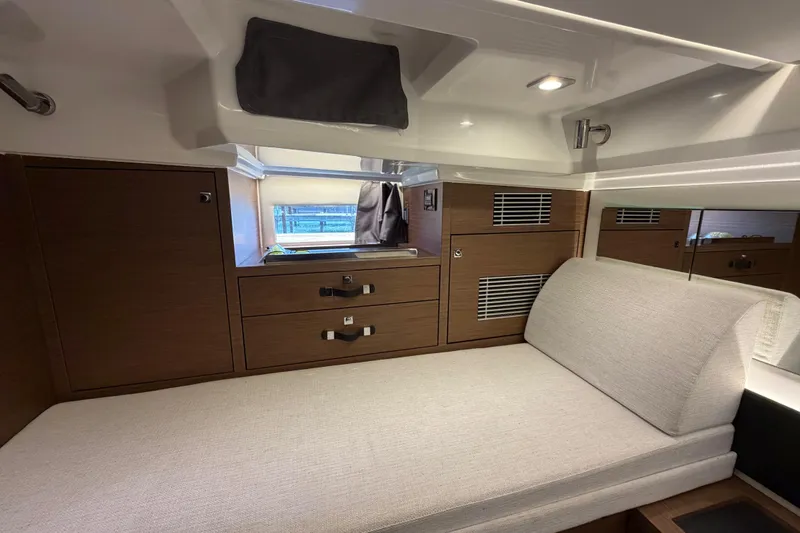 Slide: The Image of 2023 Jeanneau Leader 12.5 WA cabin interior with modern wood cabinetry and comfortable seating. - 40