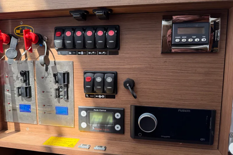 Slide: The Image of Control panel of 2023 Jeanneau Leader 12.5 WA boat with switches and displays. - 42