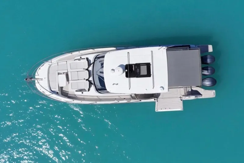 Slide: The Image of Aerial view of 2023 Jeanneau Leader 12.5 WA yacht on turquoise water. - 6