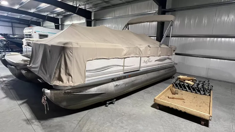 The Image of 2005 Smoker Craft Sun Cruiser pontoon boat in storage facility. - 1
