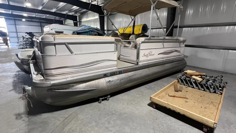 Slide: The Image of 2005 Smoker Craft Sun Cruiser pontoon boat in storage facility. - 11