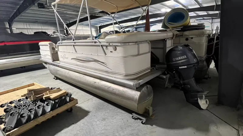 Slide: The Image of 2005 Smoker Craft Sun Cruiser pontoon boat in storage facility. - 12