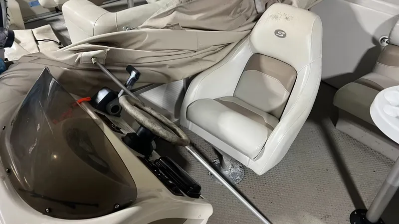 Slide: The Image of Interior of a 2005 Smoker Craft Sun Cruiser boat with helm and seat. - 6
