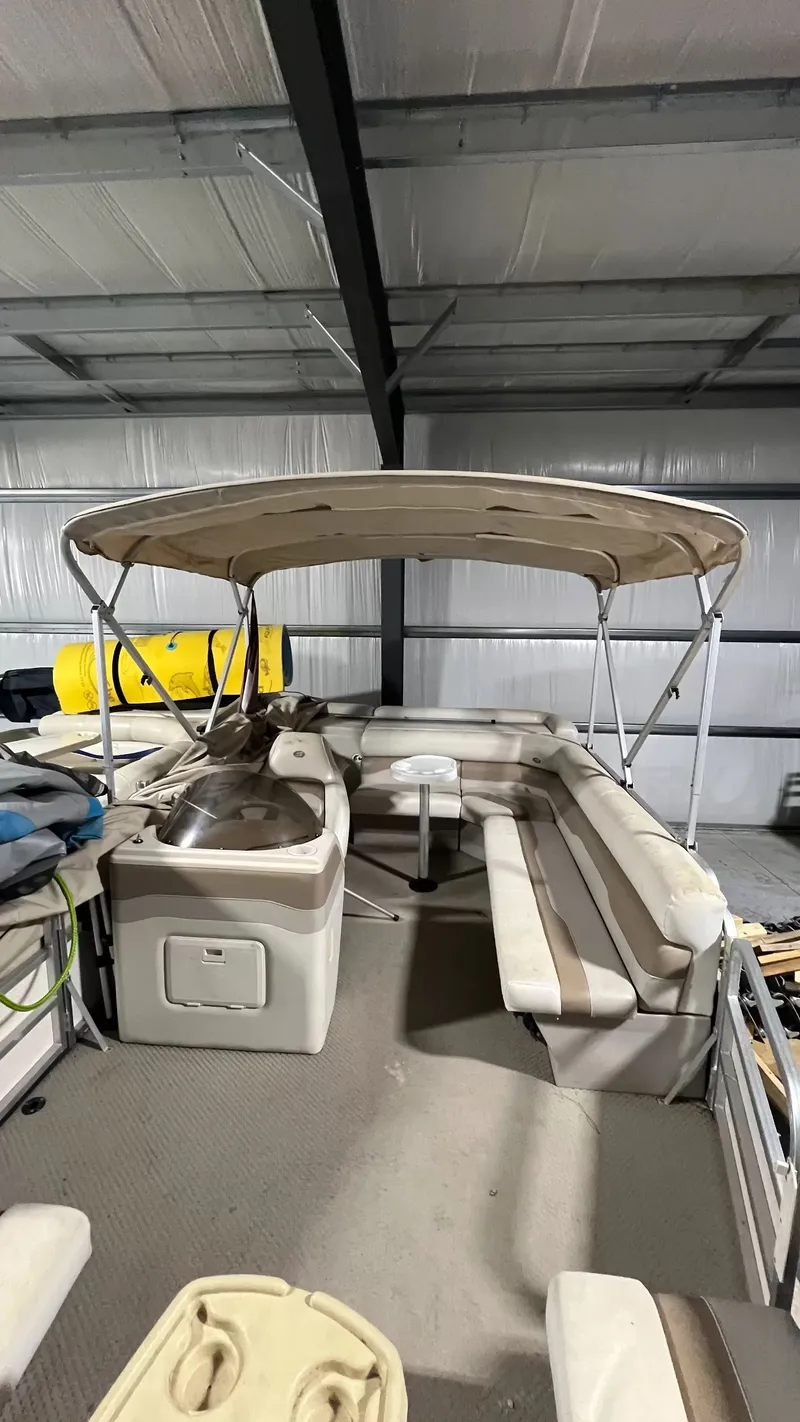 Slide: The Image of 2005 Smoker Craft Sun Cruiser pontoon boat in warehouse. - 8