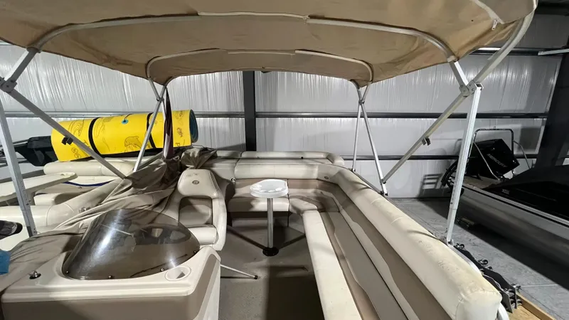 Slide: The Image of 2005 Smoker Craft Sun Cruiser pontoon boat in warehouse. - 9