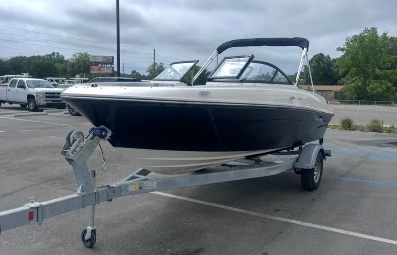 Slide: The Image of 2026 Bayliner VR4 Bowrider OB parked on trailer outdoors. - 7