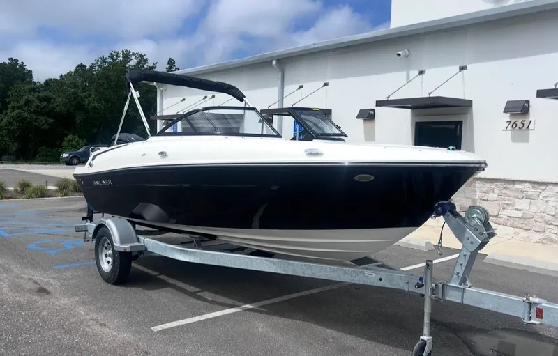 Slide: The Image of 2026 Bayliner VR4 Bowrider OB on trailer in front of building. - 8