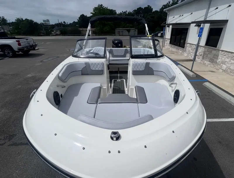 Slide: The Image of 2026 Bayliner VR4 Bowrider OB with gray seating outdoors. - 9