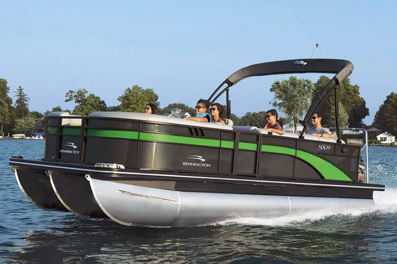 Slide: The Image of 2023 Bennington 20 SXSB pontoon boat on a lake with passengers. - 11