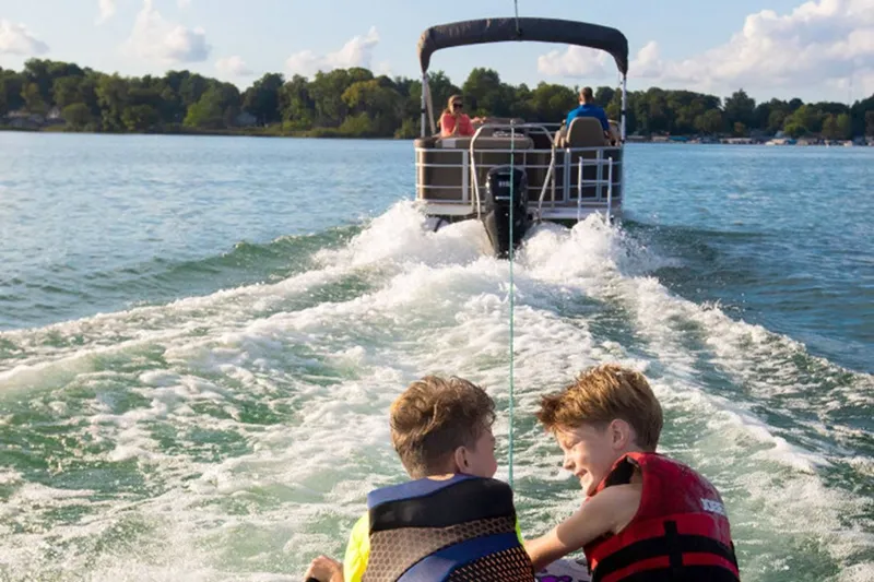 Slide: The Image of Two kids enjoying watersports behind a Bennington 20 SXSB boat. - 3