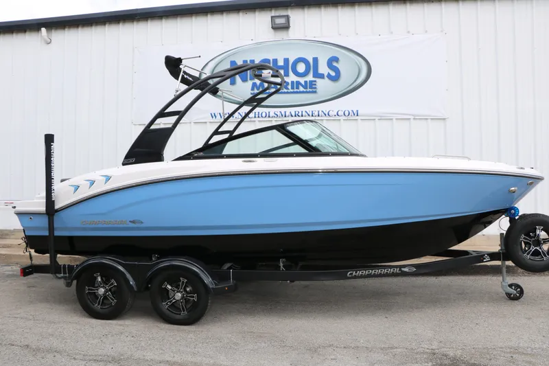 Slide: The Image of 2026 Chaparral 21 SSi boat on trailer in front of building. - 3